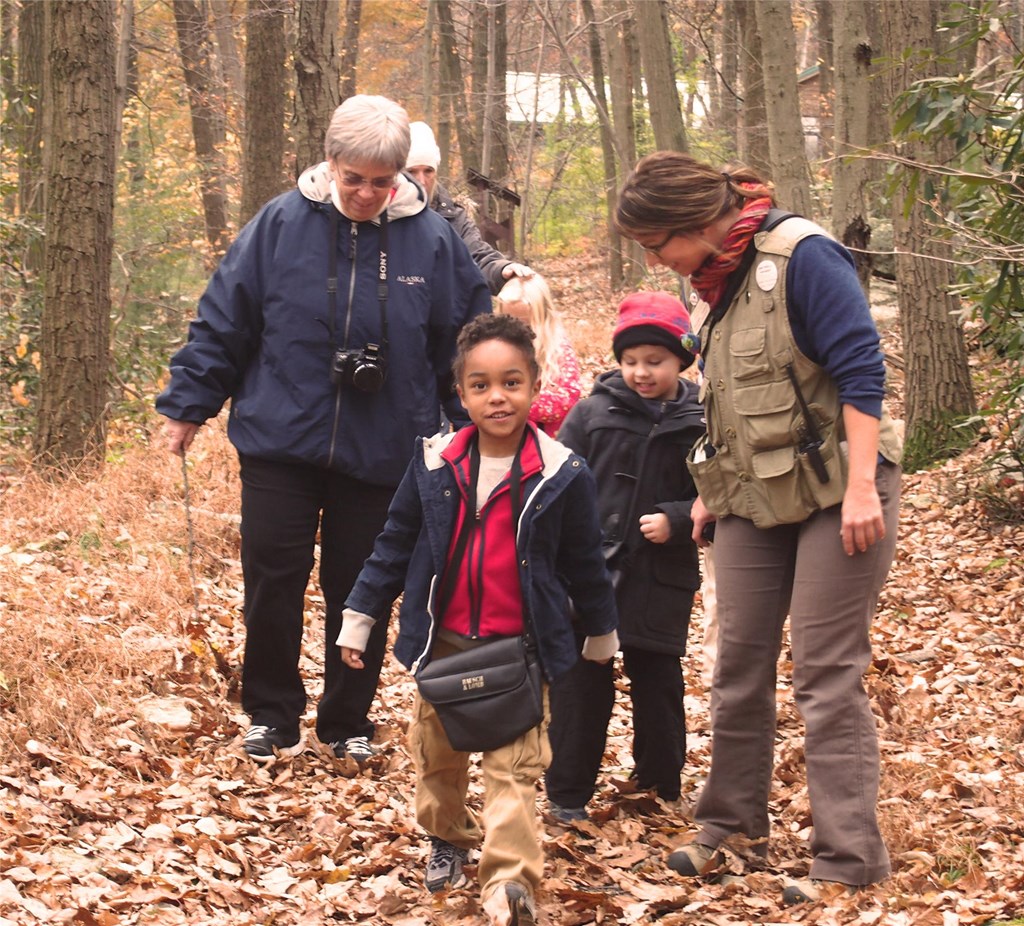 Educator Rachel guides young students on the trails
