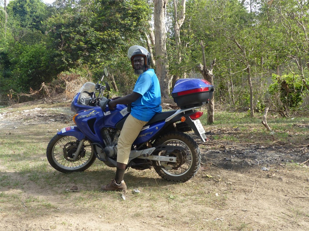 Momodou on his Motorbike While Doing Surveys in The Gambia