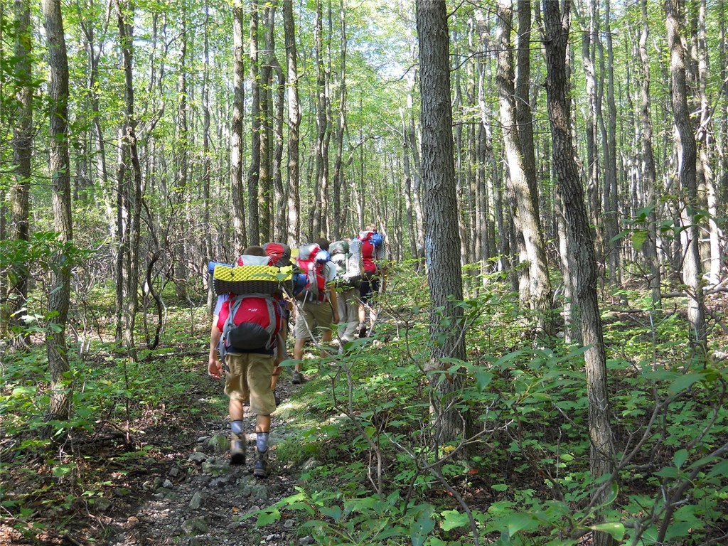 HM Conservation Corps backpacking through the forest