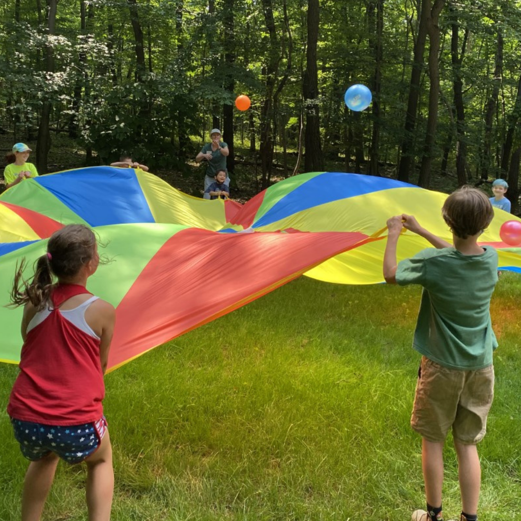Campers playing with a parachute