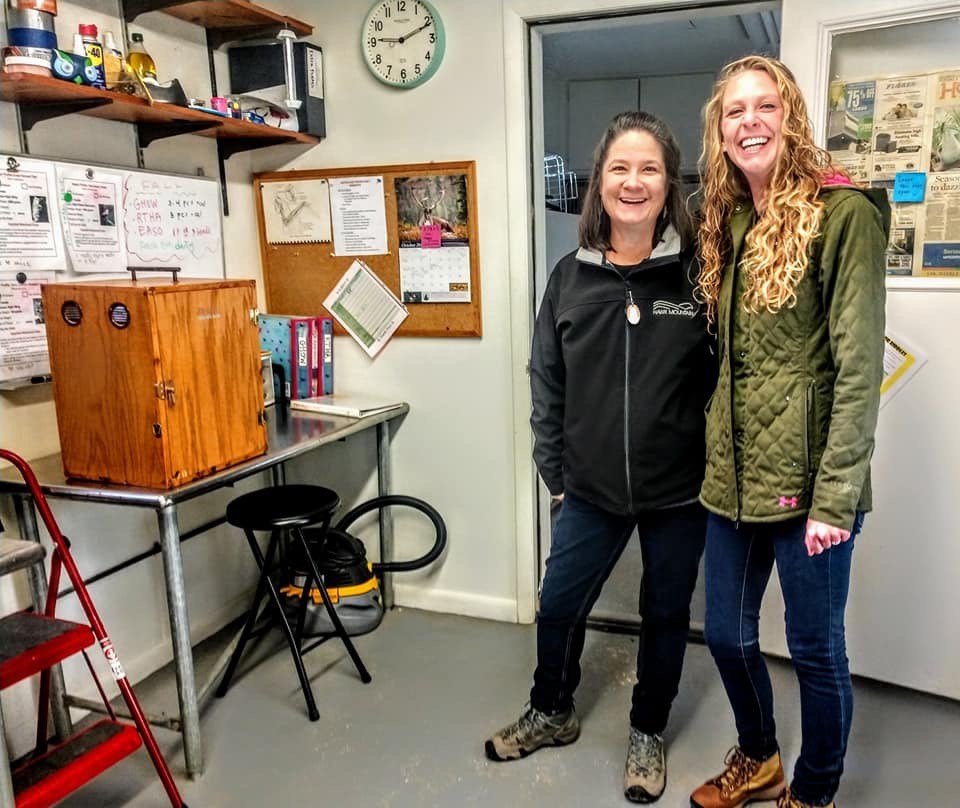 Volunteers Cheryl and Kelsie pose in Hawk Mountain's Raptor Care. 