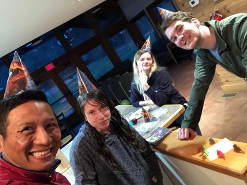 Lanso, Sandra, Shannon, and Colin celebrating a birthday in the Trainee Residence.