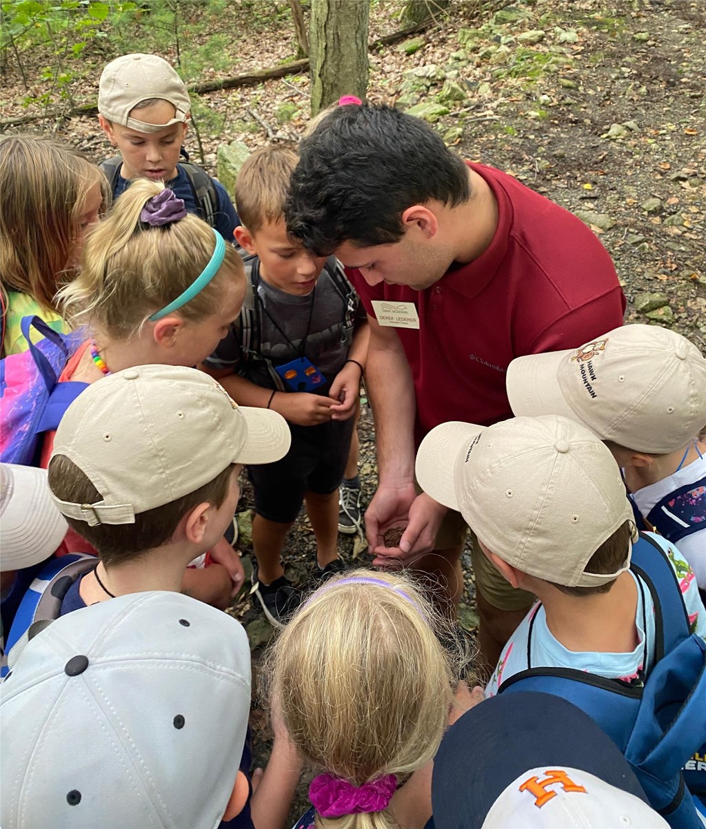 Education Trainee Derek Lederer with campers