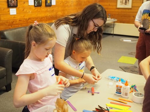Karissa assisting a young visitor