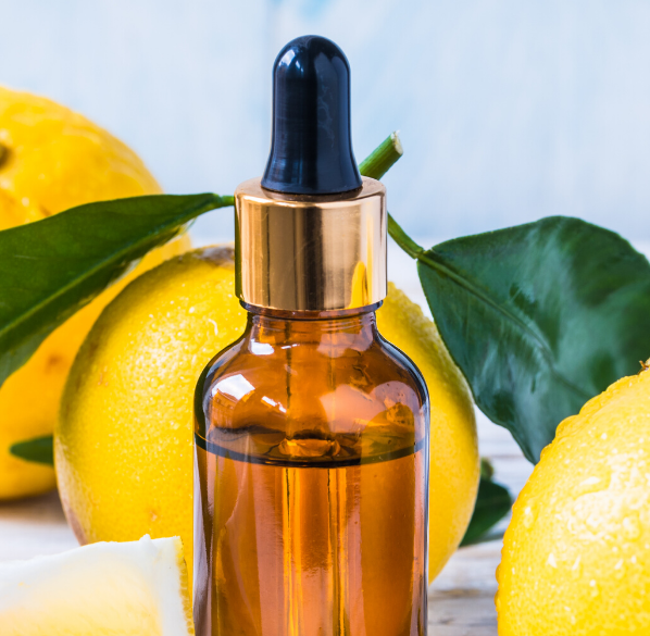 Essential oil bottle with lemons Essential oil bottle with lemons