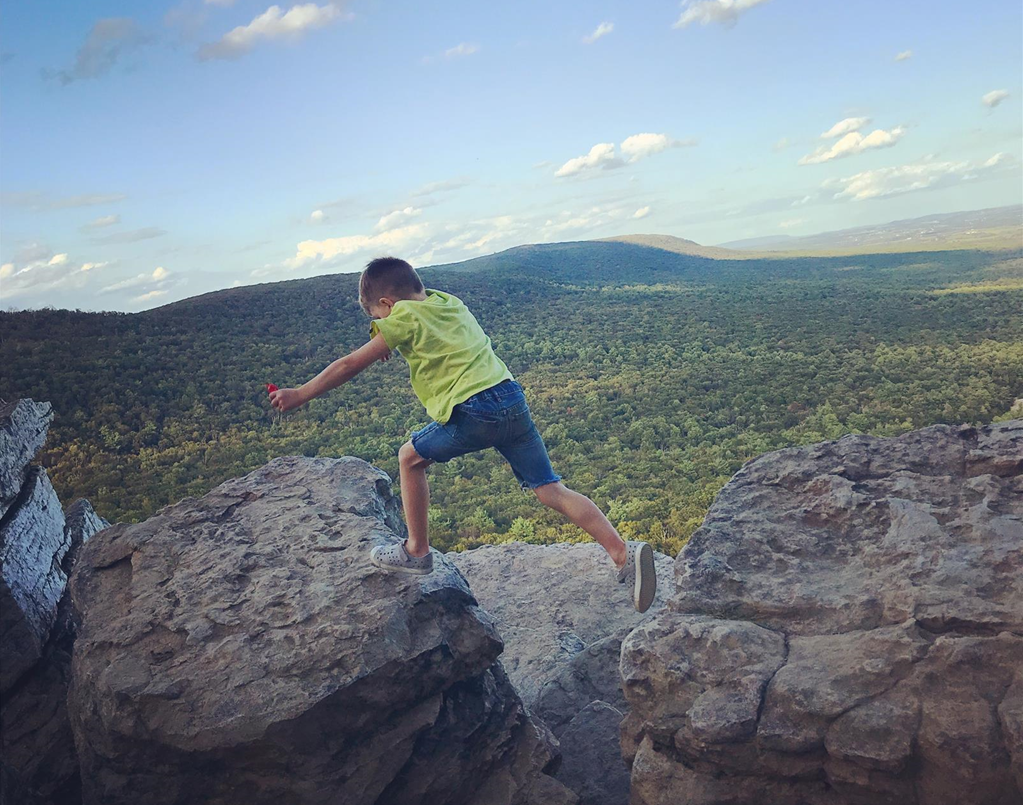 Young Visitor Hopping Between Boulders at South Lookout Young Visitor Hopping Between Boulders at South Lookout
