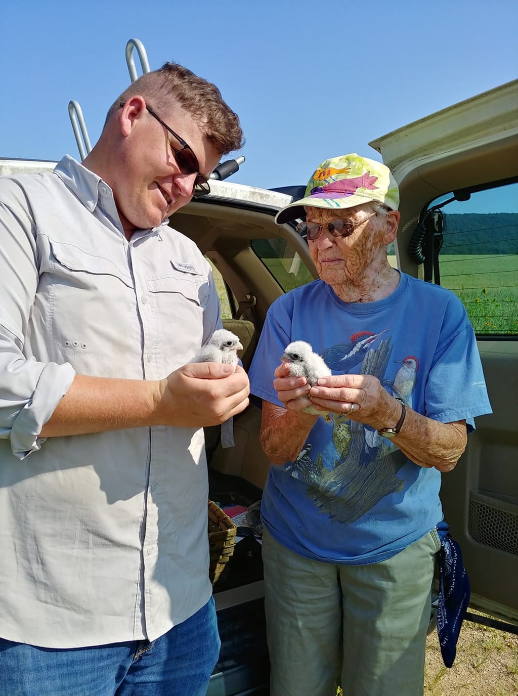 HMS Biologist and Volunteer hold recently banded American kestrel chicks