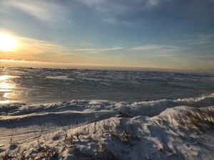 The sun rises over the frozen Lake Ontario