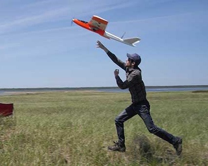 Dr. David Bird launching drone Dr. David Bird launching drone