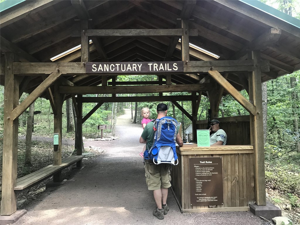 Father and daughter pass through the trail entrance gate
