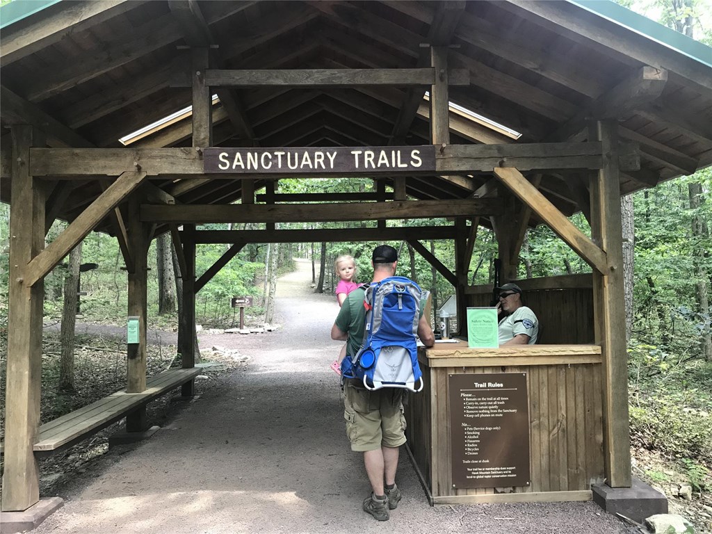 Visitors at Entrance Gate Father and daughter pass through the trail entrance gate